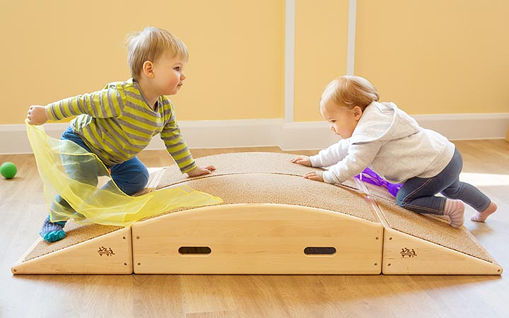 two kids on play ramp