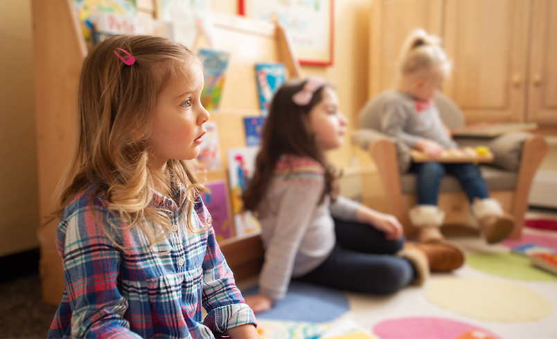 A child is observing what is going on in an early years classroom