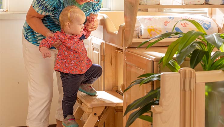 Child climbing up changing table steps