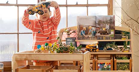 A child playing at the Activity top shelf